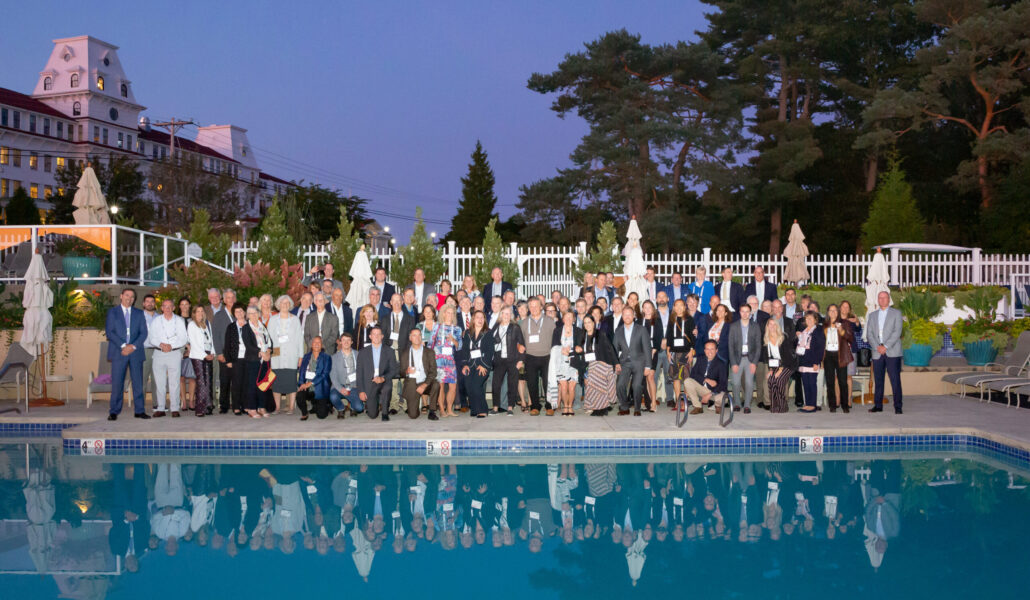 group-photo-of-bigelow-forum-attendees-standing-outside-near-pool